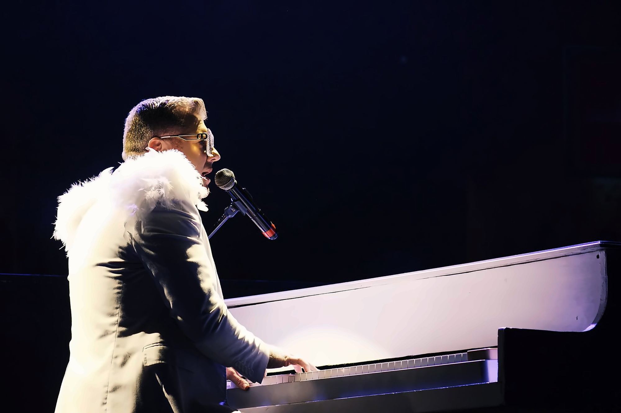 Evan Cullum singing at the piano